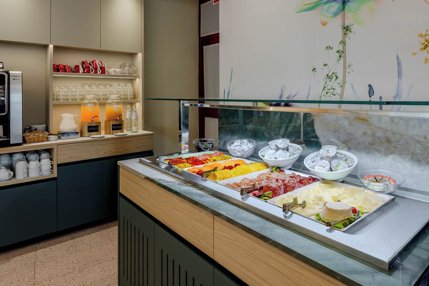 A buffet area with various food options and a coffee station.