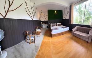 A modern bedroom with a bed, a sofa, a fan, and a dining area with chairs. - 7 Art Villa (ELLA)
