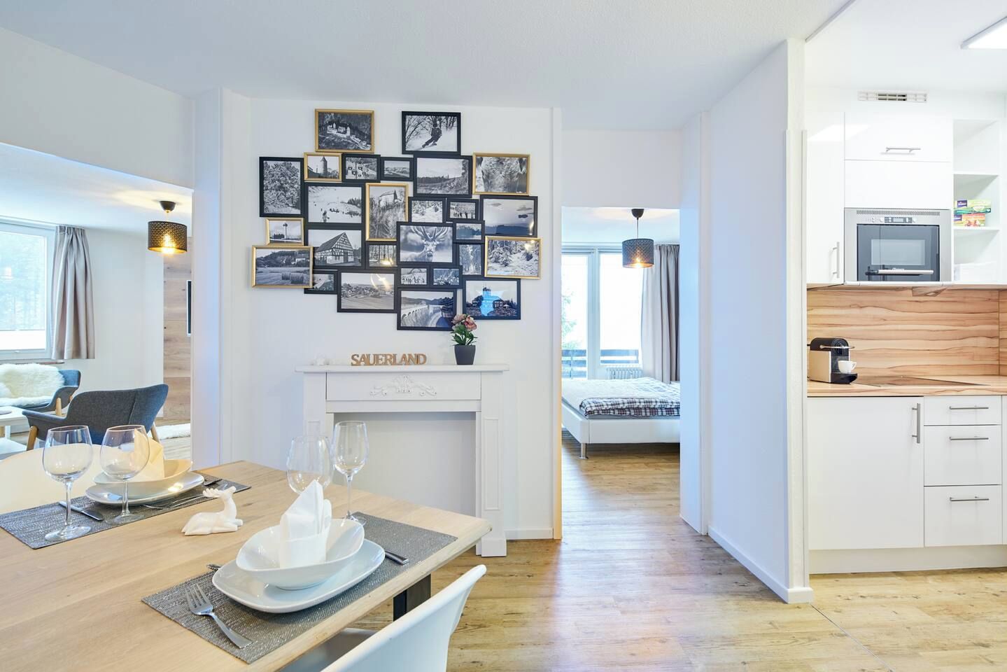 A modern interior with a dining area, a fireplace, and a kitchen.