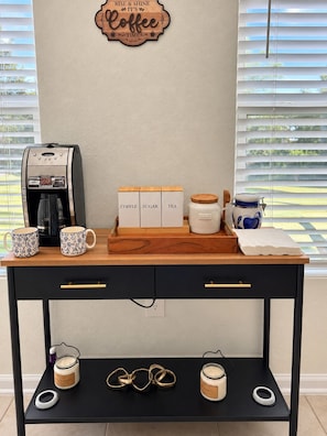 A coffee station with a coffee maker, sugar, tea containers, and mugs on a wooden counter. - Charming 3-bedroom townhome  Close 2 Beaches in marvelous St. Augustine (St. Augustine)