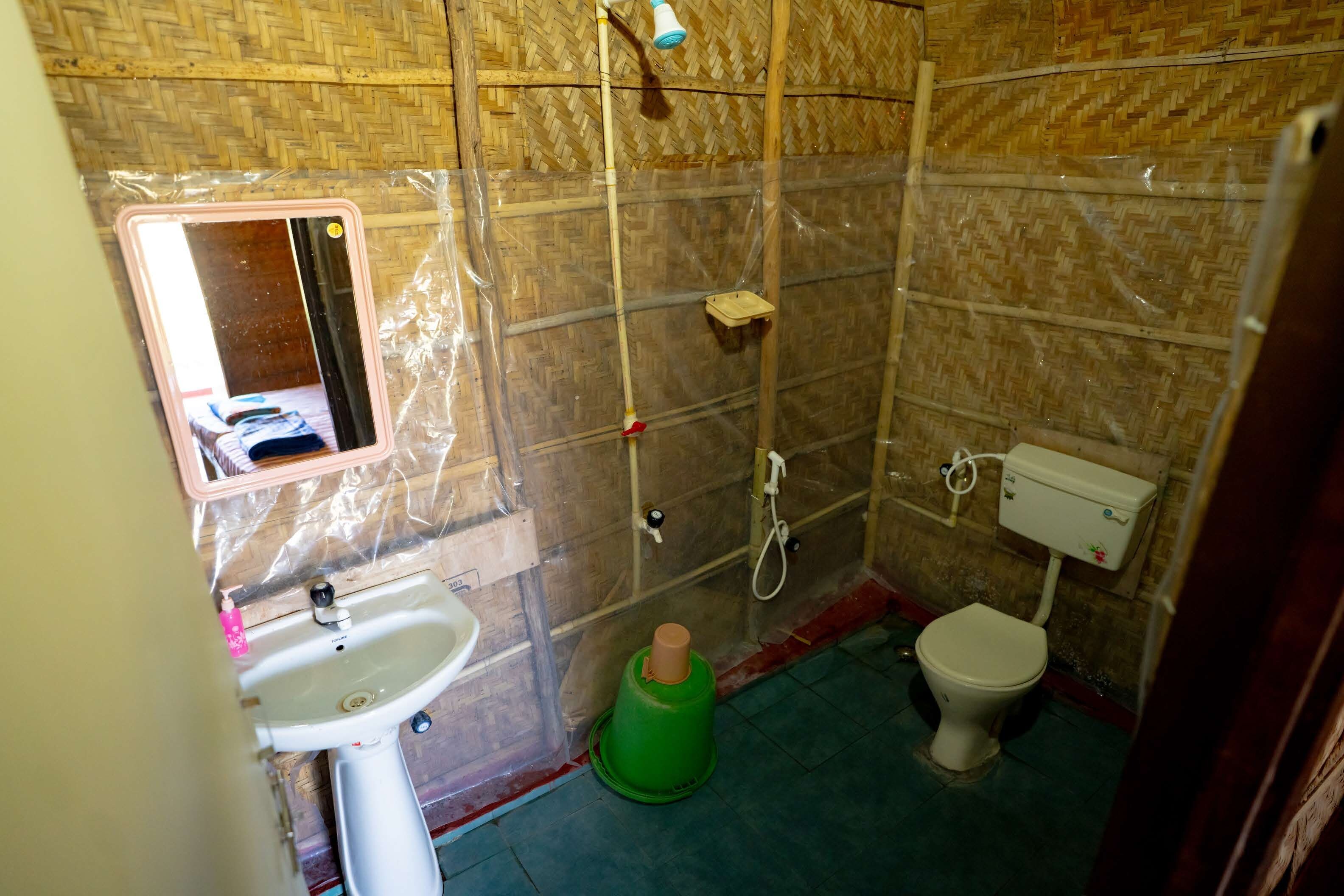 A bathroom with a sink, toilet, and shower area.