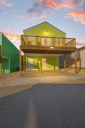 A two-story building with a balcony and a garage. - University Inn (Lafayette)