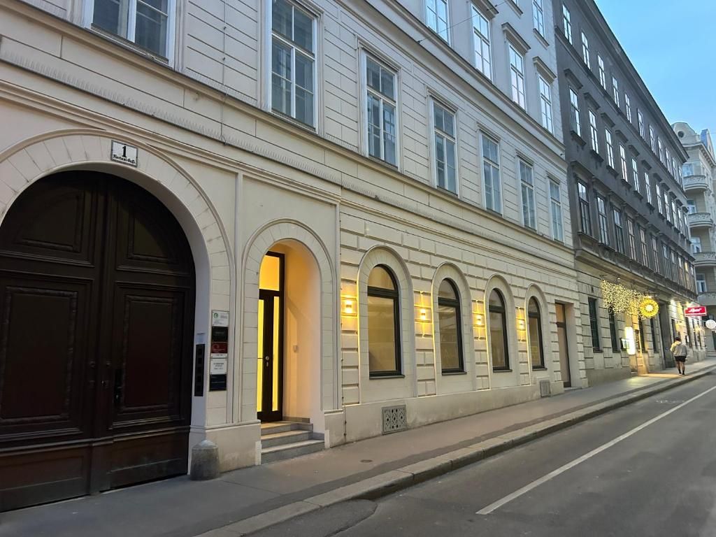 A building with large arched windows and a prominent entrance with steps.