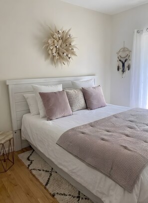 A neatly made bed with a white headboard, a patterned throw blanket, and a decorative wall hanging. - Guesthouse 'Chez Le Vigneron - Pinot noir' with Spa (Avirey Lingey)