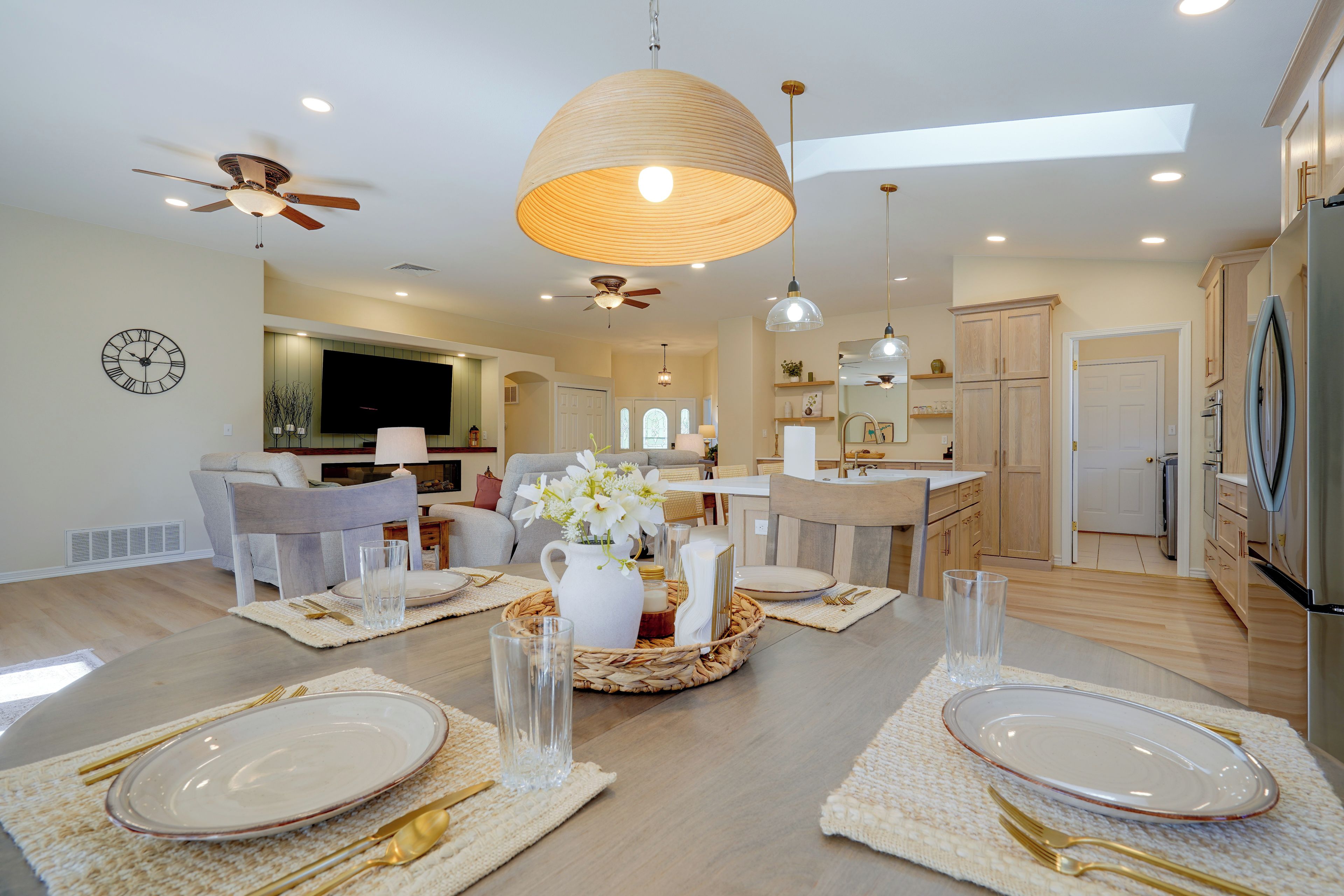 A modern kitchen with a refrigerator, oven, and sink.
