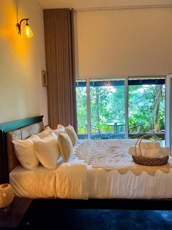A bed with a headboard, pillows, a blanket, and a basket.