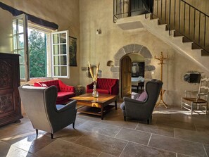 A spacious living area with a high ceiling, a staircase, and a view of greenery outside. - New Listing (Durfort-et-Saint-Martin-de-Sossenac)