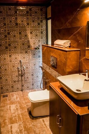 Un baño con baldosas estampadas, un inodoro, un lavabo y un armario.