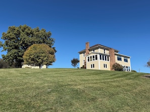 A two-story house with a large lawn and a prominent tree. - 3 bedroom farmhouse located in the beautiful Shenandoah valley, just off I -81 (Staunton)