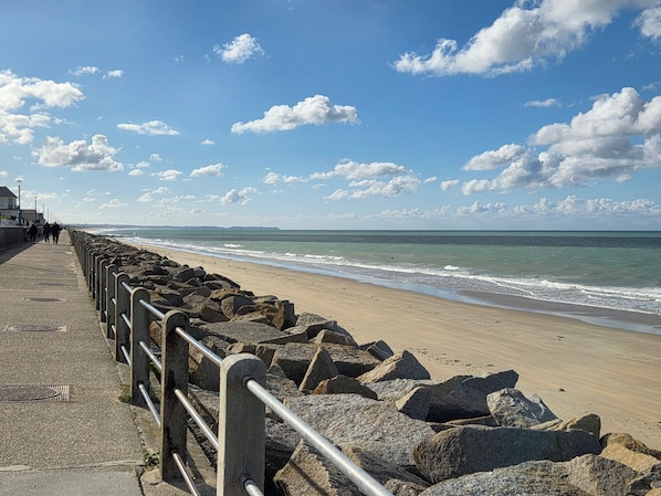 A coastal walkway with a metal railing, leading to a sandy beach. - New Listing (Hauteville-sur-Mer)