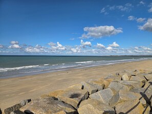 Ein Strand mit blauem Himmel und Wellen.