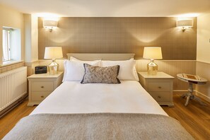 A neatly made bed with white linens, two bedside lamps, a radio, and a small round table with a chessboard. - Host & Stay | Ryedale (Hutton-le-Hole)