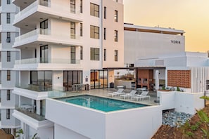 A modern hotel with a rooftop pool, multiple balconies, and a sign that reads 'YORK'. - Panoramic Ocean-View 3BR York Penthouse (Umhlanga)