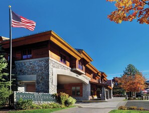 Ein Hotel mit einer steinernen Fassade, einer Flagge und einem Schild, das es als Marriott Residence Club kennzeichnet.