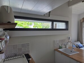 A kitchen with a window, a sink, and a countertop.