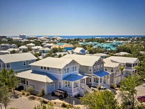 A coastal residential area with multiple two-story houses featuring gabled roofs and front porches.