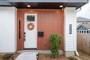 A house entrance with a white door, a wreath, a mailbox, and a small tree. - NEW HOUSE Nash Bash Babes 2 BED/2BATH - Sleeps 10 (Nashville)