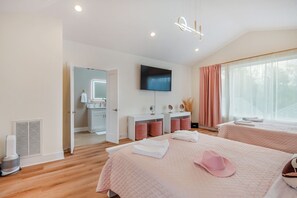 A hotel room with two beds, a TV, a bathroom, and a large window with curtains. - NEW HOUSE Nash Bash Babes 2 BED/2BATH - Sleeps 10 (Nashville)