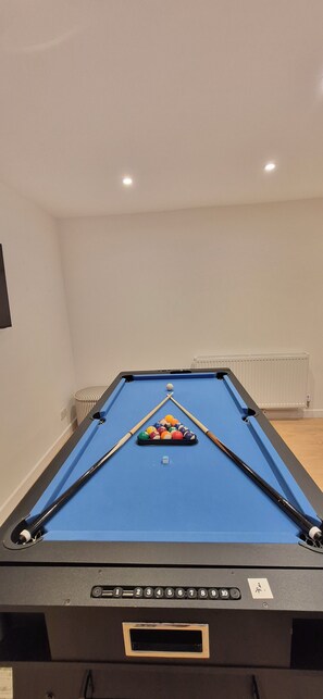 A pool table with a blue felt surface, a set of pool cues, and a rack of billiard balls. - NEW I 3 BEDROOM HOUSE I DUDLEY I WEST MIDLANDS I POOL TABLE I FAMILY (Dudley)