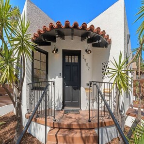 A building with a black door, a number '2902' on the wall, and a 'hello' mat at the entrance. - South Park Spanish Stunner Renovated & Central (San Diego)
