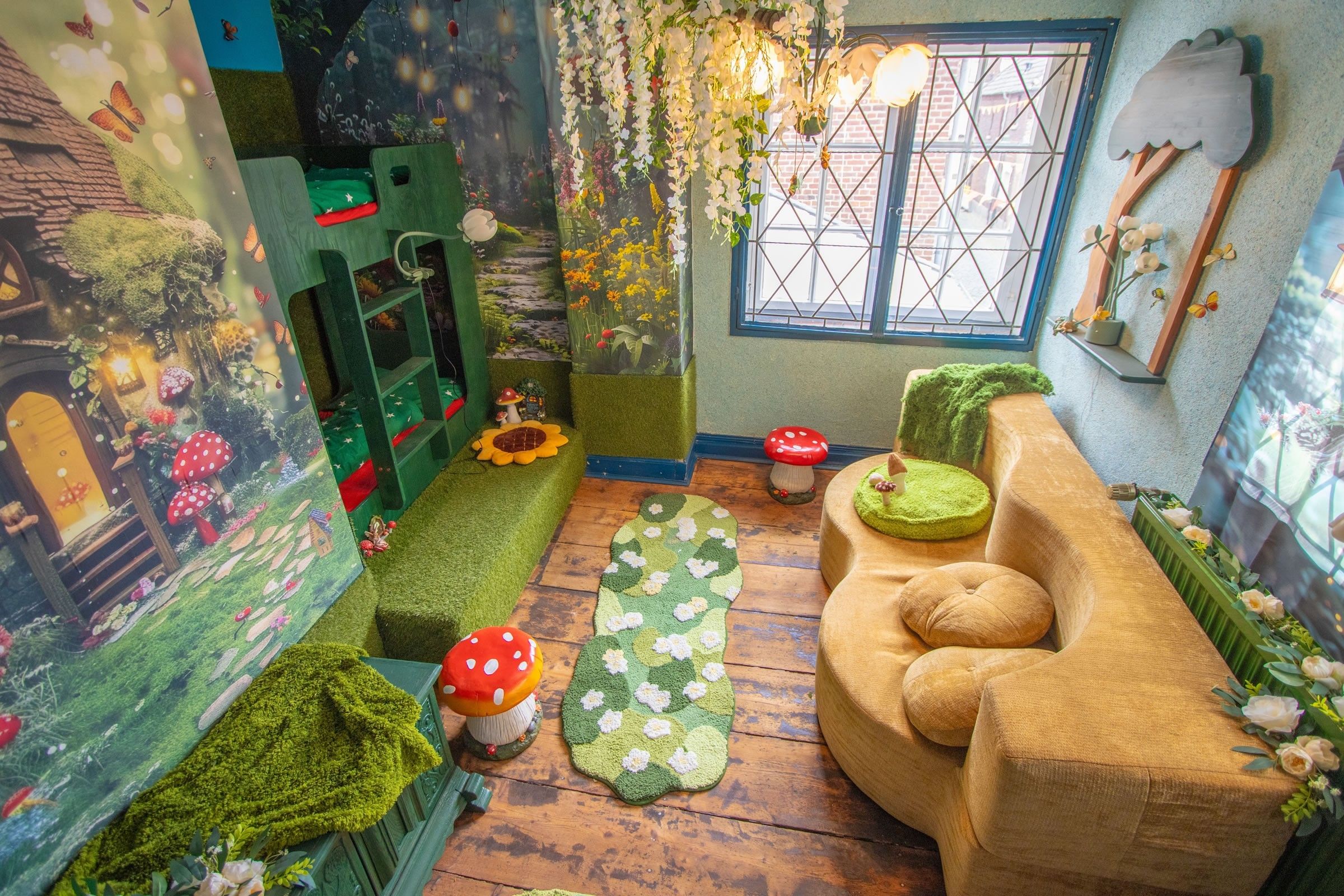 A cozy room with a green sofa, a small table, and a window with a view.
