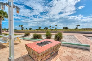 A paved outdoor area with a brick planter, a street lamp, and a clear sky with clouds. - Tropic Terrace Suite 40 (Treasure Island)
