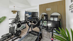 A home gym with treadmills, a stationary bike, and a rowing machine. - Spacious 5-bedroom house in serene Kansas City (Kansas City)