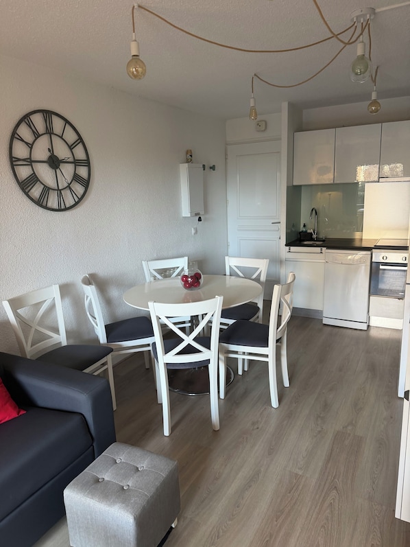 Een moderne keuken met witte kasten, een inbouwoven en een spoelbak.
