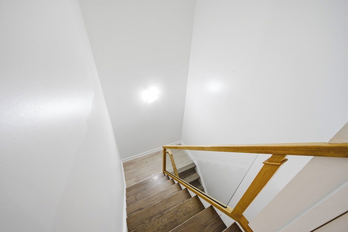 A staircase with wooden handrails and a wooden floor.