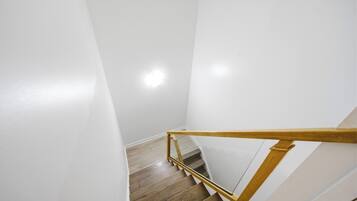 A staircase with wooden handrails and a wooden floor.