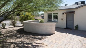 A house with a circular concrete planter, a door, and a mailbox. - Charming 3-bedroom bungalow in Sam Hughes within walking distance of the U of A (Tucson)