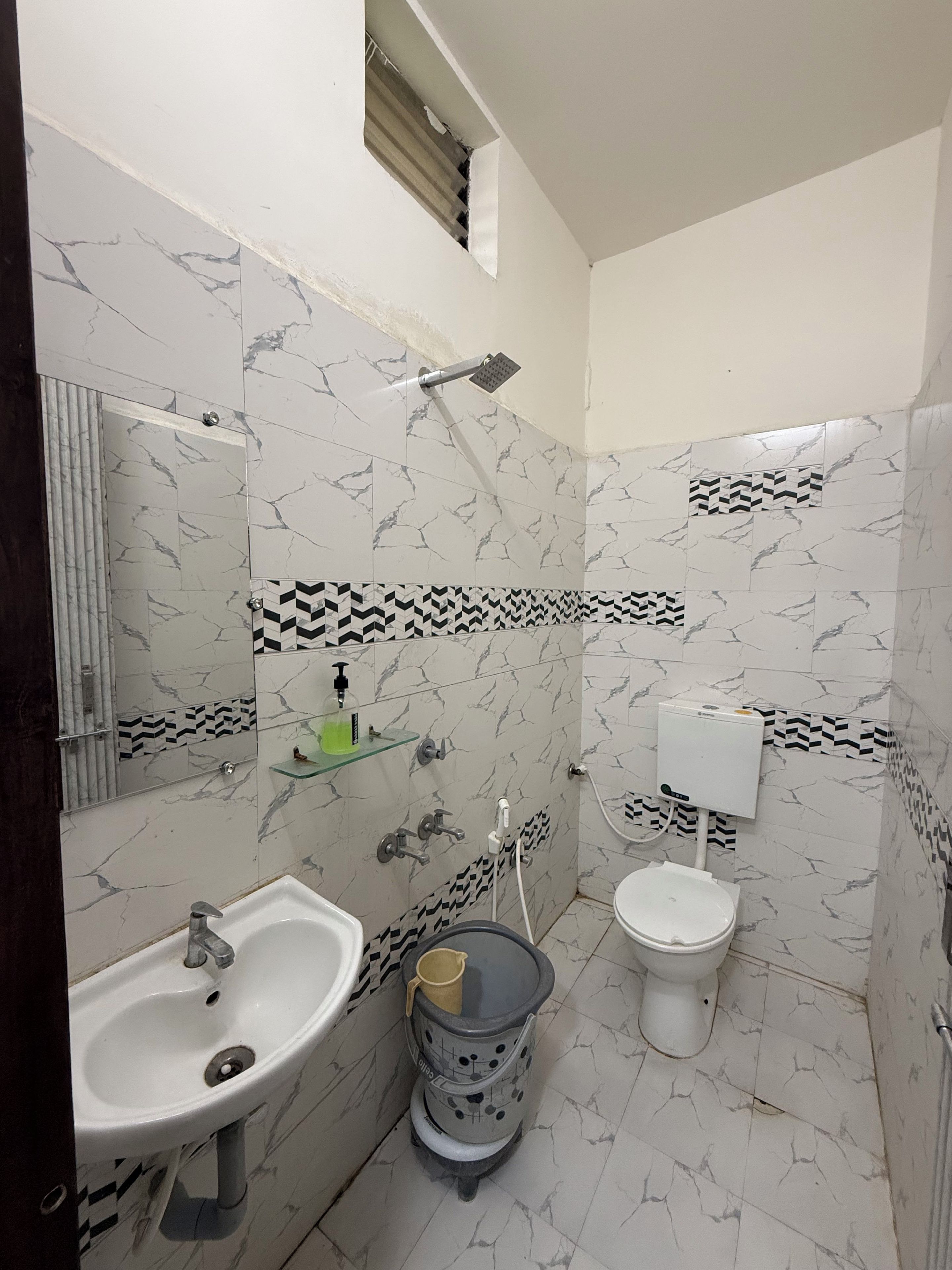 A bathroom with a sink, toilet, and shower.