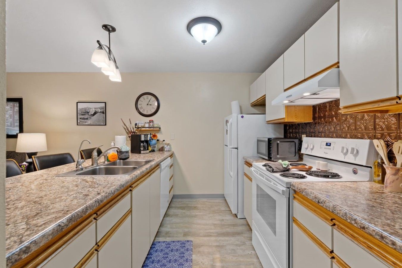 A compact kitchen with a microwave, stove, and refrigerator.