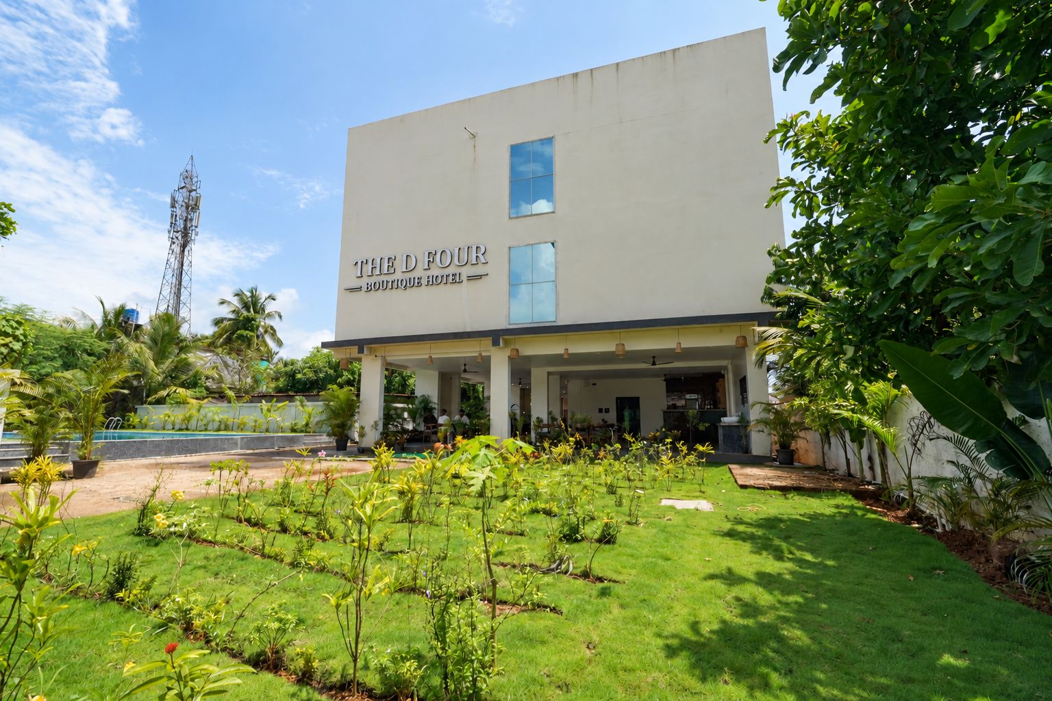 A modern building with a sign reading 'The Four Boutique Hotel.'