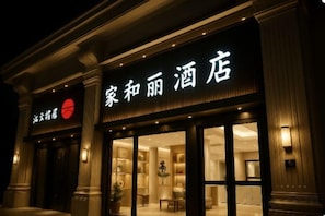 A hotel facade with illuminated signage, large windows, and a classic architectural design. - Jiahe Liyuan Hotel (Beijing Tongren Hospital Beijing Railway Station) (Beijing)