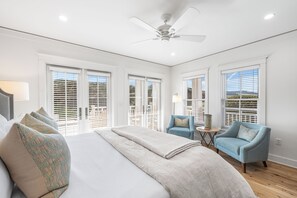 A bedroom with a large bed, a ceiling fan, and multiple windows with blinds. - Gulf-Front WaterColor "Petite" Corner Condo for 2!  Couple's Beachfront Getaway! (Santa Rosa Beach)