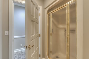A hallway with a white door and a glass door with a gold frame. - Just a short path to the lake! Private dock! 4 BR 4 BA (Estill Springs)