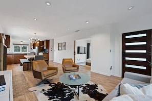 A modern living space with a kitchen, dining area, and seating area. - Your Modern Lux Pool Resort in the Heart of SD (San Diego)