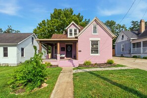 A pink single-story house with a front porch, a visible mailbox, and a well-maintained lawn. - Hot Tub + 2 Kings | Near KY Horse Park | 3BR (Georgetown)