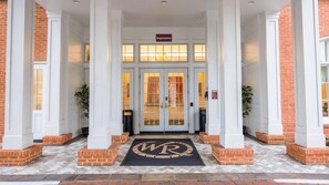 A hotel entrance with a registration sign, double doors, and a doormat with initials. - Historic Escape – 1BR Villa at Westgate Williamsburg (Williamsburg)