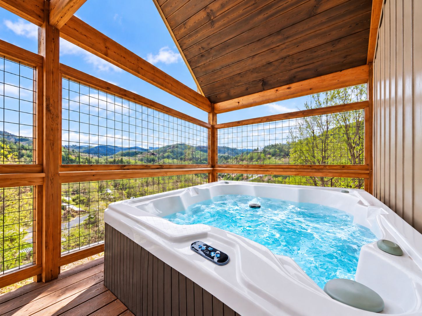 Covered hot tub with stunning mountain views and a private deck retreat