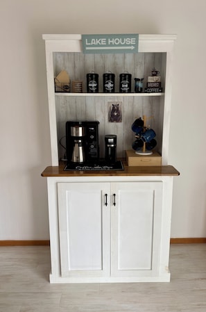 A coffee station with a sign reading 'LAKE HOUSE' above it, featuring a coffee maker, sugar, and tea containers. - Paddle Point Retreat - Mountain & Lake Views - Fire Pit (McHenry)