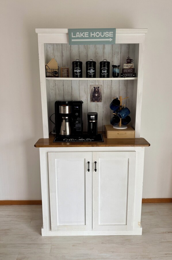 A coffee station with a sign reading 'LAKE HOUSE' above it, featuring a coffee maker, sugar, and tea containers. - Paddle Point Retreat - Mountain & Lake Views - Fire Pit (McHenry)