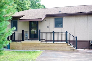 A two-story building with a front porch, a mailbox, and a number '80' on the wall. - Paddle Point Retreat - Mountain & Lake Views - Fire Pit (McHenry)