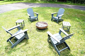 A circular outdoor seating arrangement with four Adirondack chairs and a central fire pit. - Paddle Point Retreat - Mountain & Lake Views - Fire Pit (McHenry)