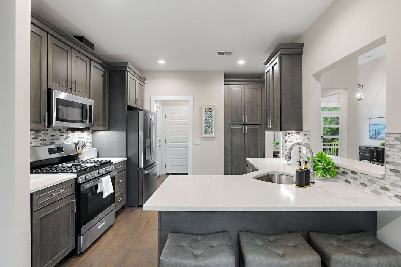 Large kitchen with stainless steel appliances. Fully equipped with everything you need for your stay! Coffee machine + coffee is provided. Kitchen island provides seating for 3.