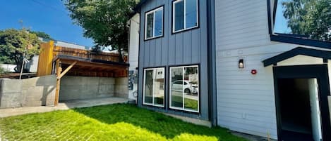 A modern two-story house with a well-maintained lawn and a visible garage door.