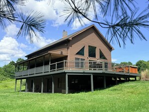 A two-story house with a balcony and a covered porch. - Hot Tub • Private Pond • 12-Acr Retreat • Sleep 14 (Binghamton)