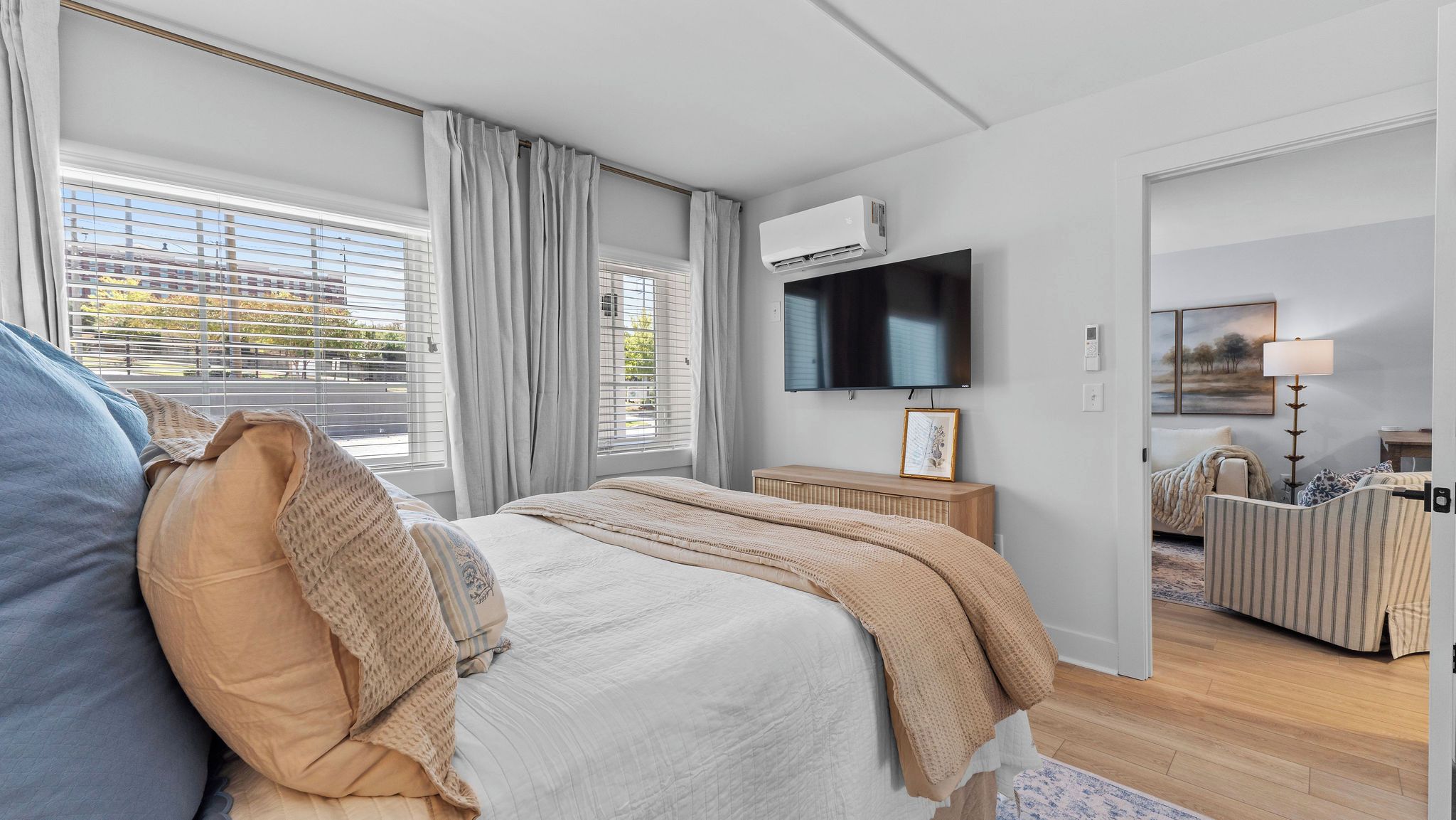 Ein Schlafzimmer mit Bett, Fernseher, Nachttisch und Lampe.
