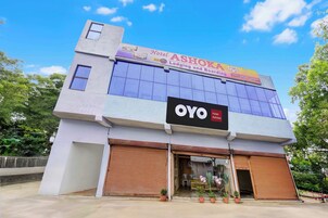 A building with a sign for 'Ashoka Hotel' and 'OYO Hotel Ashoka'.
